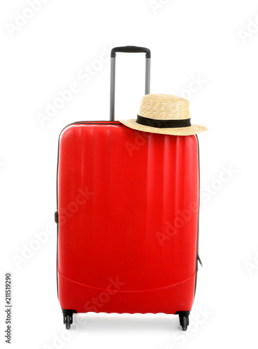Packed suitcase with hat on white background