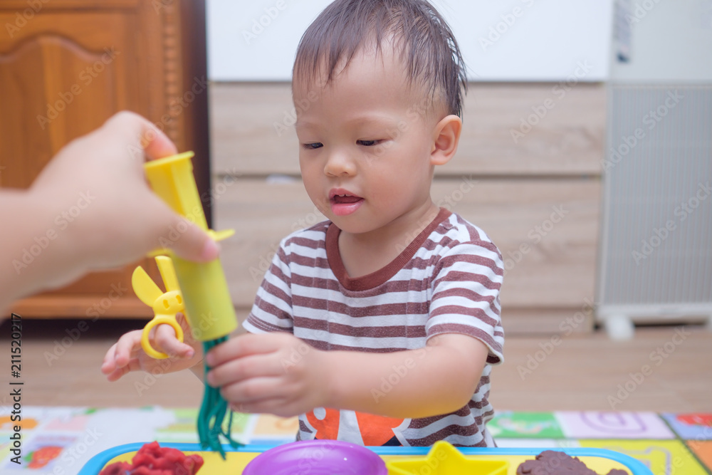 Cute little Asian 18 months old toddler boy child having fun