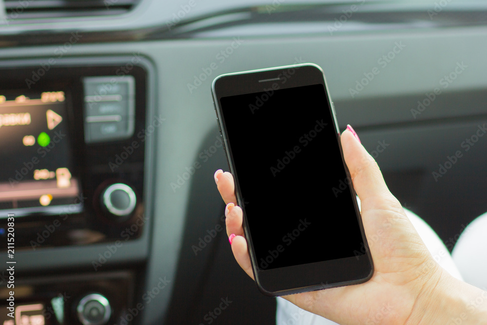 girl sitting in the car holding a smartphone in her hand, close-up girl sitting in the car holding a smartphone in her hand, close-up
