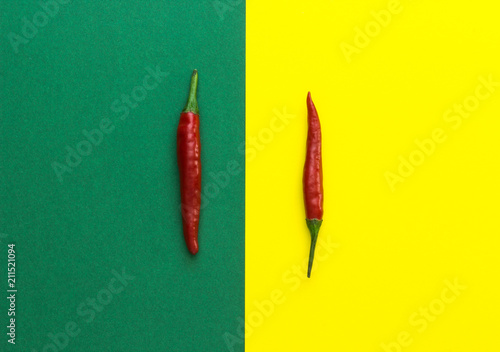 top view of red chili pepper on yellow-green background