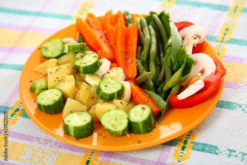 Salad with cucumbers, boiled potato, asparagus, spices, carrots 