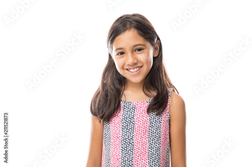 Smiling young hispanic girl posing and looking at the camera over white background