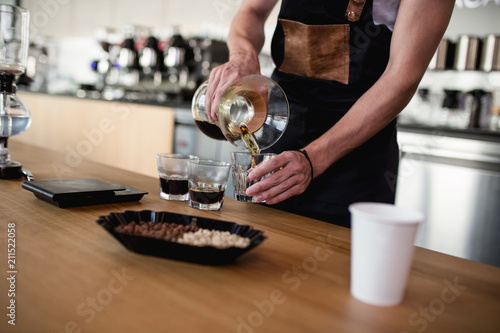 Barista making coffee in style "pour over".