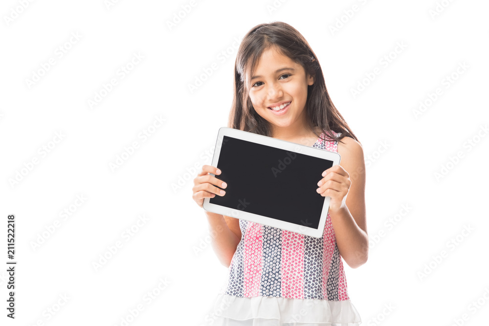 Child playing on tablet pc while standing against white background Child playing on tablet pc while standing against white background