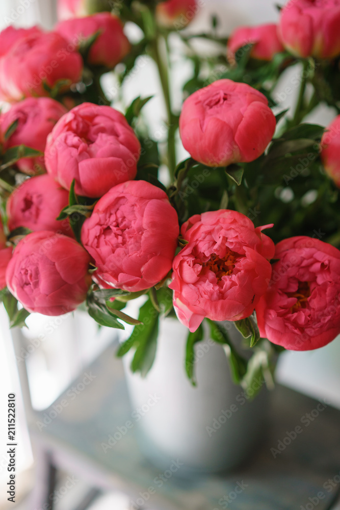 Beautiful bouquet of red peonies . Floral composition, daylight. Wallpaper. Lovely flowers in glass vase.
