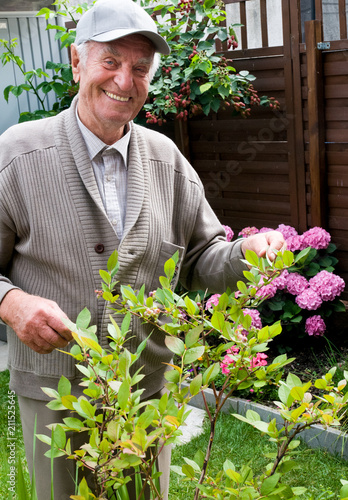 Smiling old man in his own garden