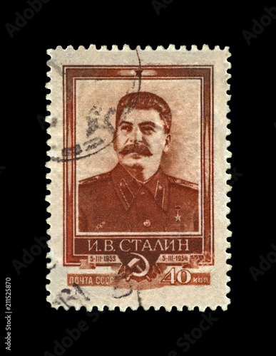 Joseph Stalin, famous soviet politician leader, 1st anniversary of the death, circa 1954. vintage canceled postal stamp printed in USSR (Soviet Union) isolated on black background.
