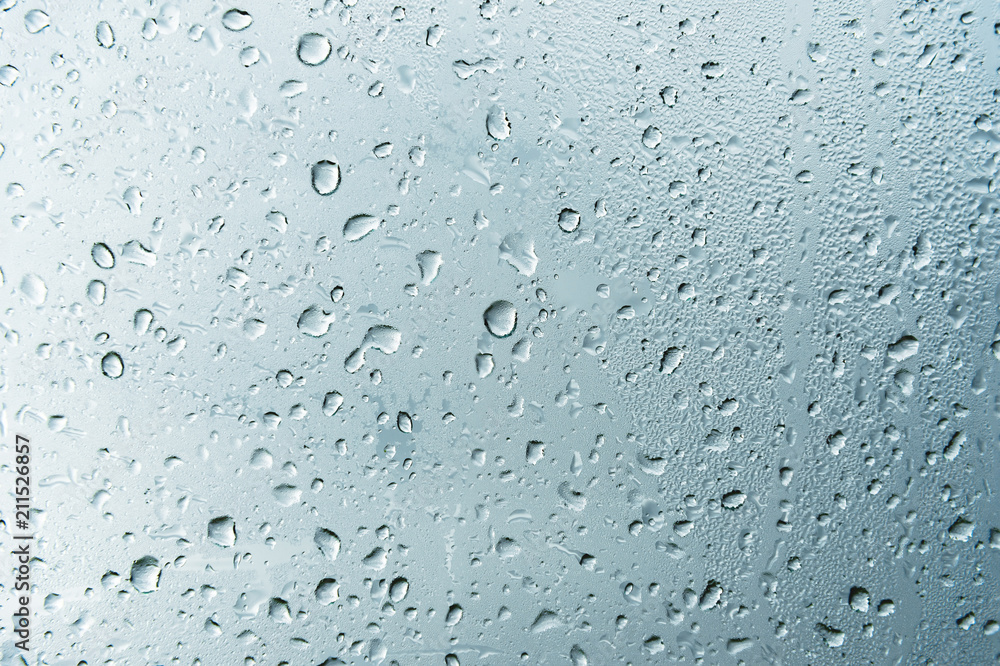 Textured background of window panes with a cloudy background. Natural pattern from a drop of rain on a cloudy background. Textured background of window panes with a cloudy background. Natural pattern from a drop of rain on a cloudy background.