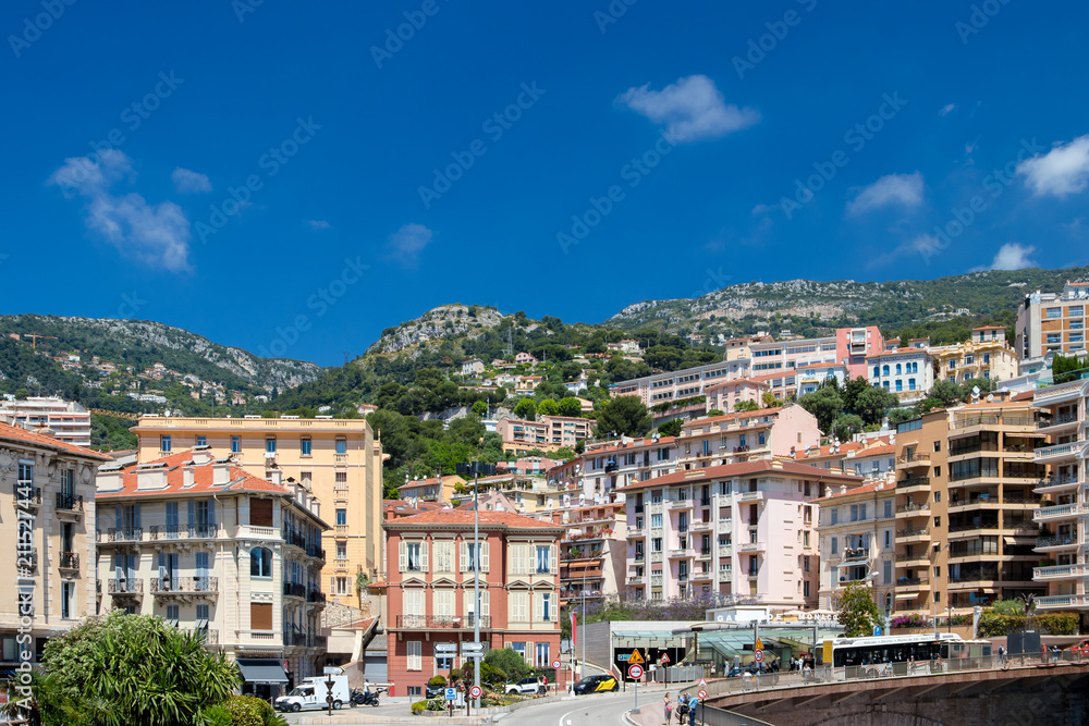 Daylight sunny view to city buildings and green trees on mountains. Monte Carlo, Monaco