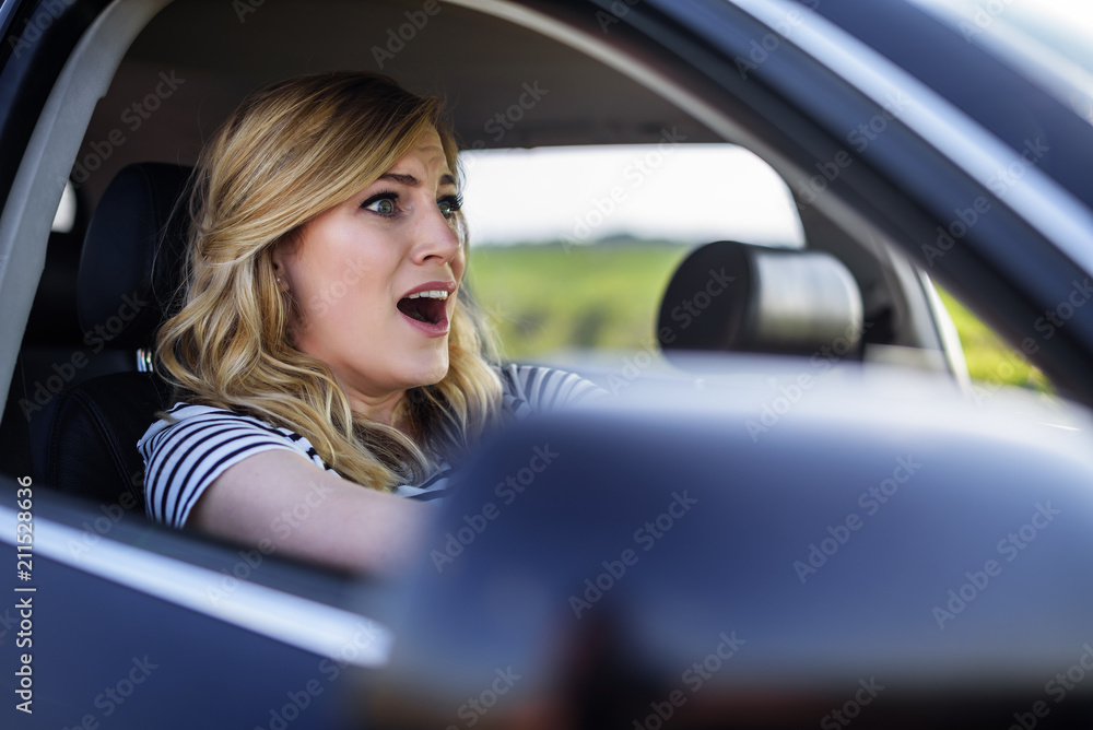 The woman driving the car in a panic.