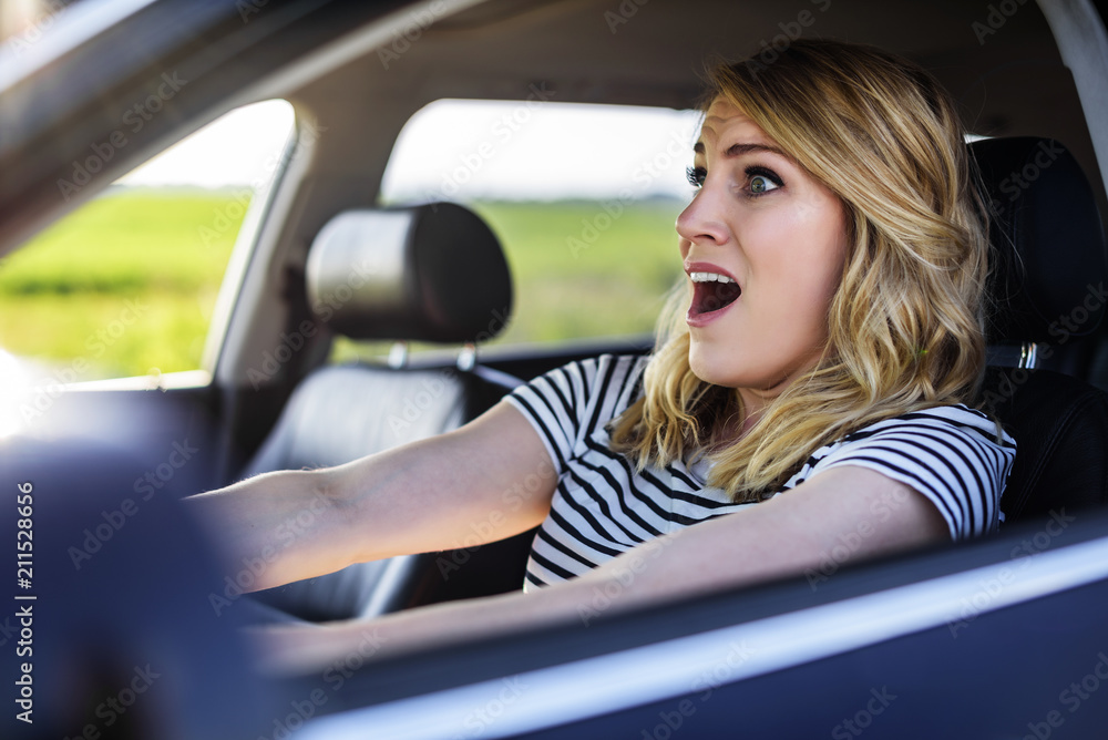 The woman driving the car in a panic. The woman driving the car in a panic.