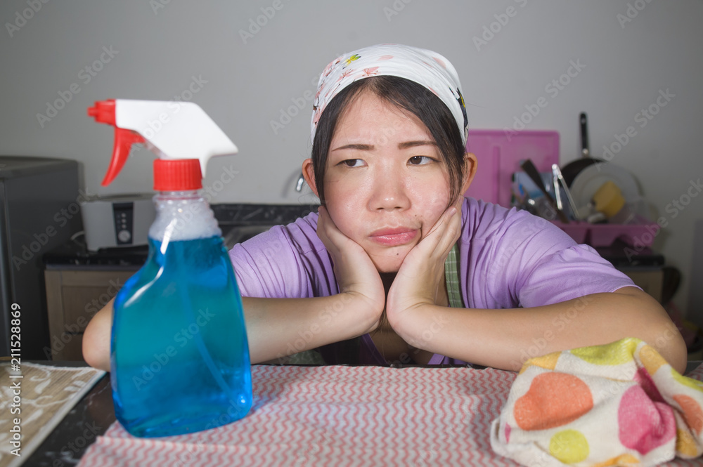 young pretty overworked and stressed Asian Korean service maid woman working domestic cleaning and washing with spray bottle angry and upset young pretty overworked and stressed Asian Korean service maid woman working domestic cleaning and washing with spray bottle angry and upset