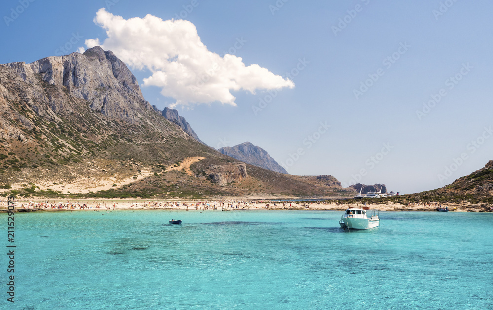 Obraz premium Balos Lagoon Blue sea, hills and boat, transparent water as a swimming pool, Crete Island, Greece