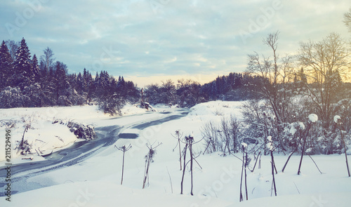 Fotografi Serene winter landscape with snow covered trees and ice-bound river