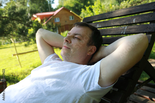 Man lying on wooden bench