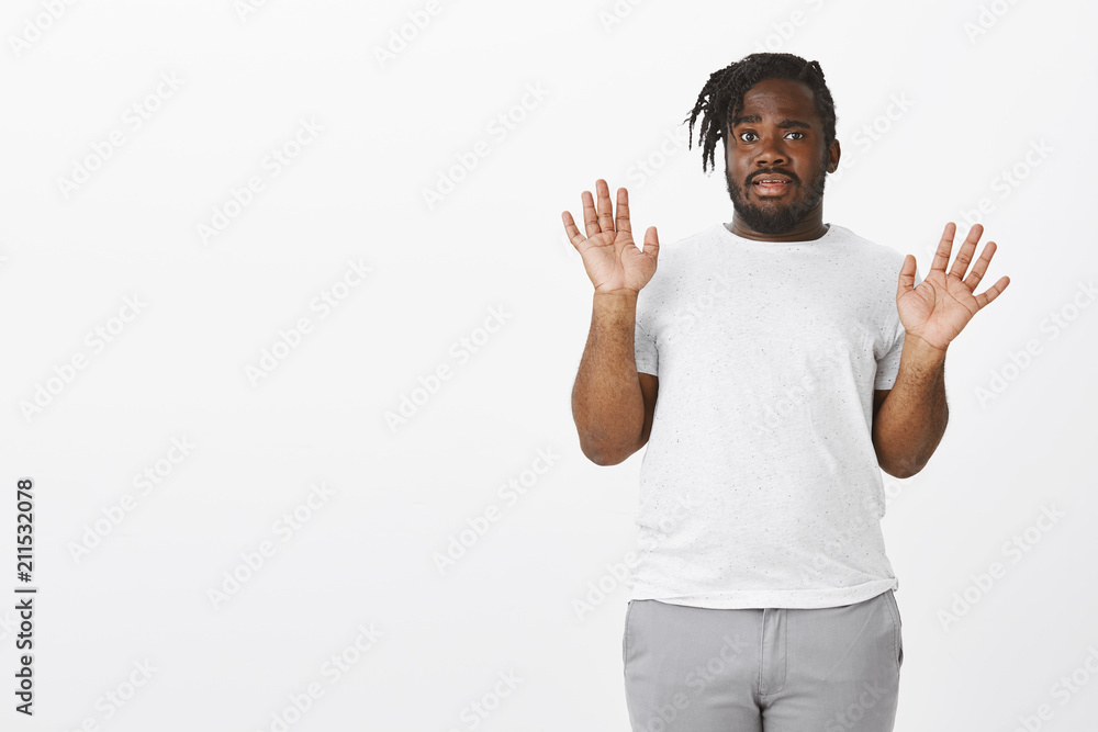 Guy is out of this shit. Anxious uninvolved funny plump dark-skinned guy in white t-shirt, raising palms in surrender gesture, being unaware or clueless, rejecting blame or being indifferent Guy is out of this shit. Anxious uninvolved funny plump dark-skinned guy in white t-shirt, raising palms in surrender gesture, being unaware or clueless, rejecting blame or being indifferent