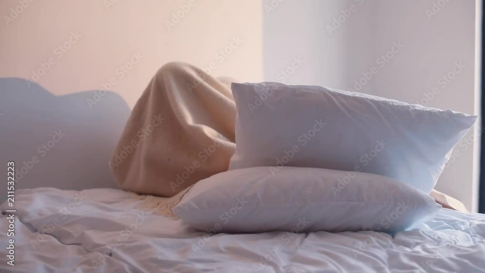 Nice happy Caucasian kids playing game under bedspread. Little boy and girl fooling around in baby's room. Coziness. Indoors. Bedroom. Nice happy Caucasian kids playing game under bedspread. Little boy and girl fooling around in baby's room. Coziness. Indoors. Bedroom.
