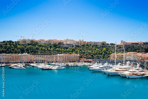 Many motor yachts docked in Fontvielle harbour on a sunny day, Monaco. photo