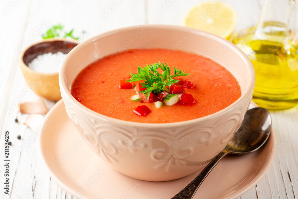 Gazpacho soup in bowl on white wooden background. Traditional spanish dish. Gazpacho soup in bowl on white wooden background. Traditional spanish dish.