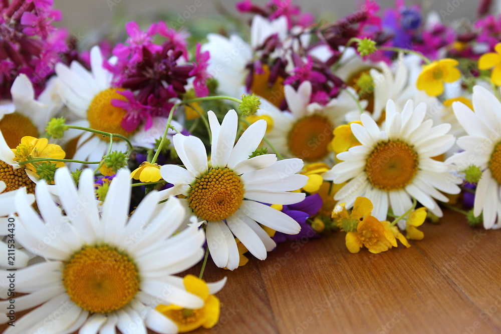 Fototapeta premium Wildflowers lie on the table
