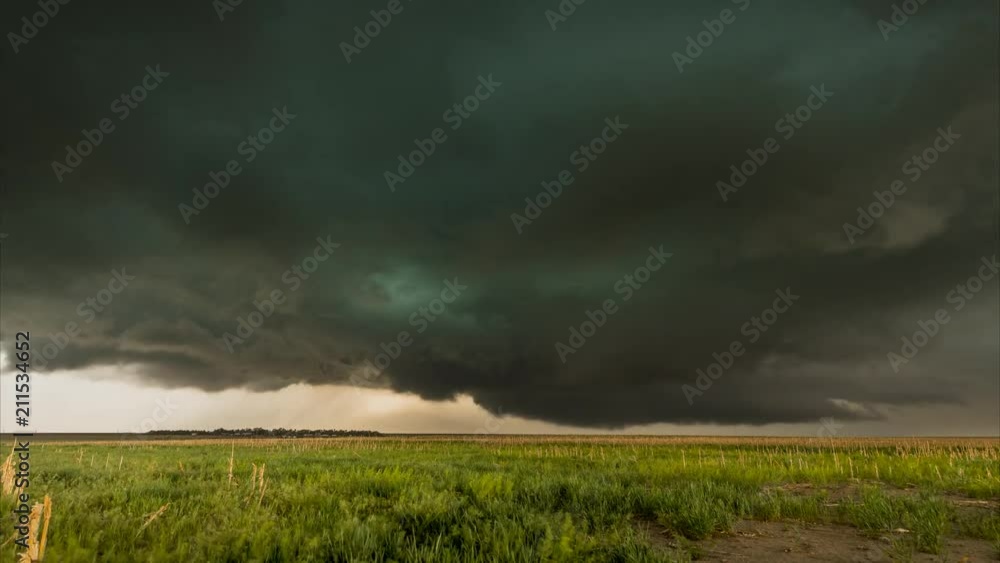 A large tornadic mesocyclone supercell inflow with a green glow of hail sucks in energy as it begins to transform into a tornado. A large tornadic mesocyclone supercell inflow with a green glow of hail sucks in energy as it begins to transform into a tornado.