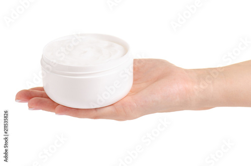 White jar of cream for a body in hands on a white background isolation