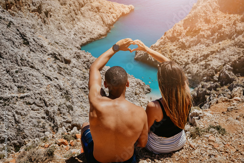 Chania , Greece - June 14, 2018 : A young couple spotted over looking beautiful  Seitan Limania beach in east of Chania. Editorial photo
