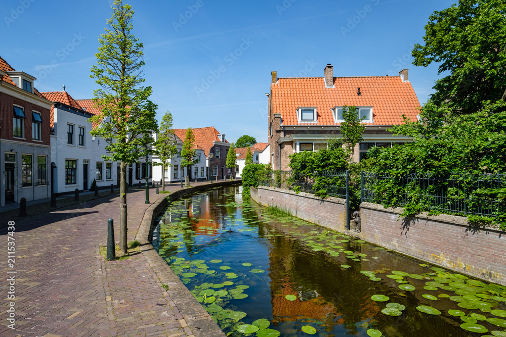 A canal in the beautiful historic center of the old village of Maasland, the Netherlands. Maasland is a village in the province of South Holland, the Netherlands