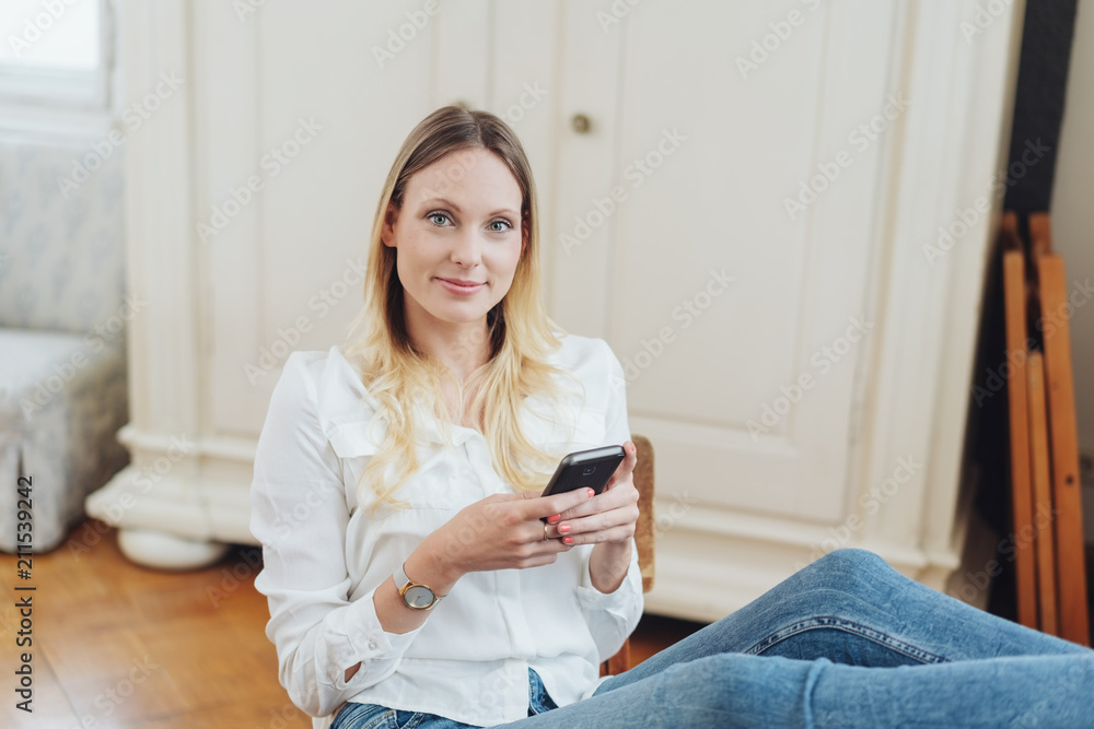 Friendly young woman relaxing with her feet up