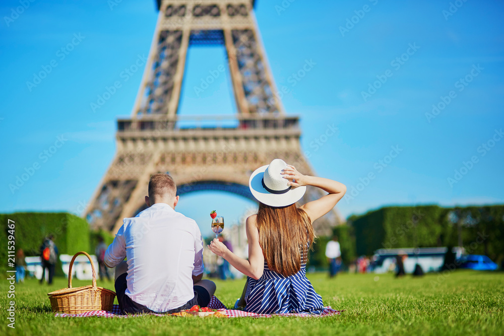Couple having picnic near the Eiffel tower in Paris