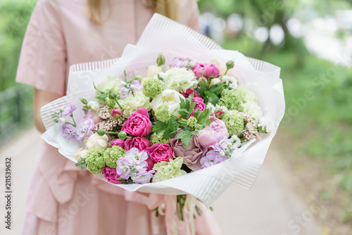 Wallpaper Mural Young girl holding a beautiful summer bouquet. flower arrangement with peonies. The concept of a flower shop. Content for the catalog Torontodigital.ca