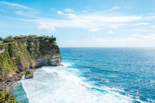 View of the cliff with waves in the sea from The Hindu Temple Pura Luhur Uluwatu, Pecatu, South Kuta, Badung Regency, Bali, Indonesia