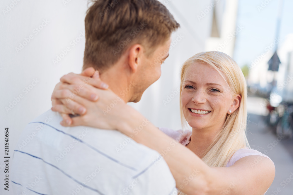 Fototapeta premium Smiling happy woman hugging her husband