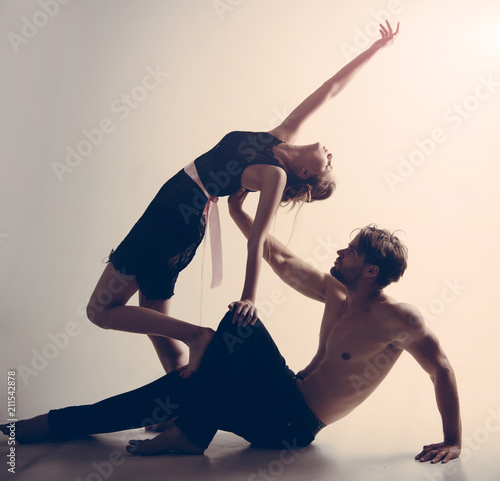 Enjoy dancing together. Muscular man and cute woman perform modern dance. Young woman and man dance love and romance. Couple of dancers. Dance school training. Romantic relationship