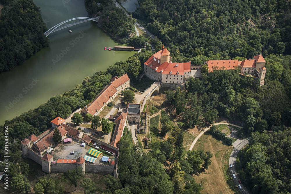 Aerial photo of Veveri castle in Czech republic surrounded by woods and river