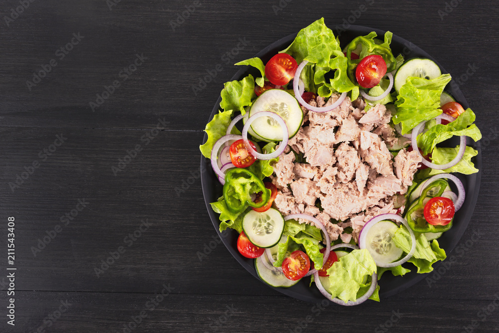 Salad with tuna and vegetables. Mediterranean food. Top view. Copy space.