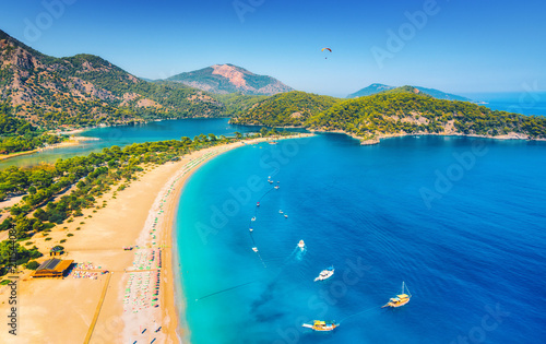 Fototapeta Naklejka Na Ścianę i Meble -  Amazing aerial view of Blue Lagoon in Oludeniz, Turkey. Summer landscape with sea spit, boats and yachts, green trees, azure water, sandy beach in sunny day. Travel. Top view of national park. Nature