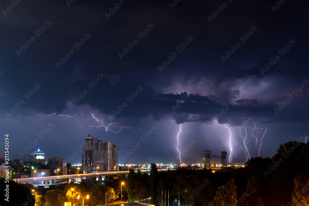 Thunder, lighting and storm in dark night sky above city Thunder, lighting and storm in dark night sky above city