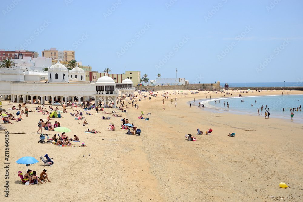Cádiz, Spain - June 21, 2018: Beach line with bathers in Cadiz. Cádiz, Spain - June 21, 2018: Beach line with bathers in Cadiz.