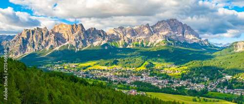 Panorama of Cortina d'Ampezzo with green meadows and alpine peaks on the background. Dolomites, Italy © pyty