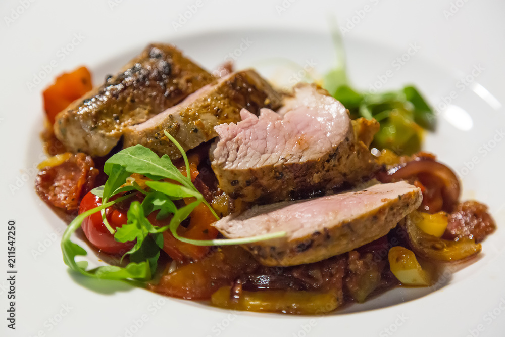 Tasty steak with potato and grilled vegetables on white plate. Close up Tasty steak with potato and grilled vegetables on white plate. Close up