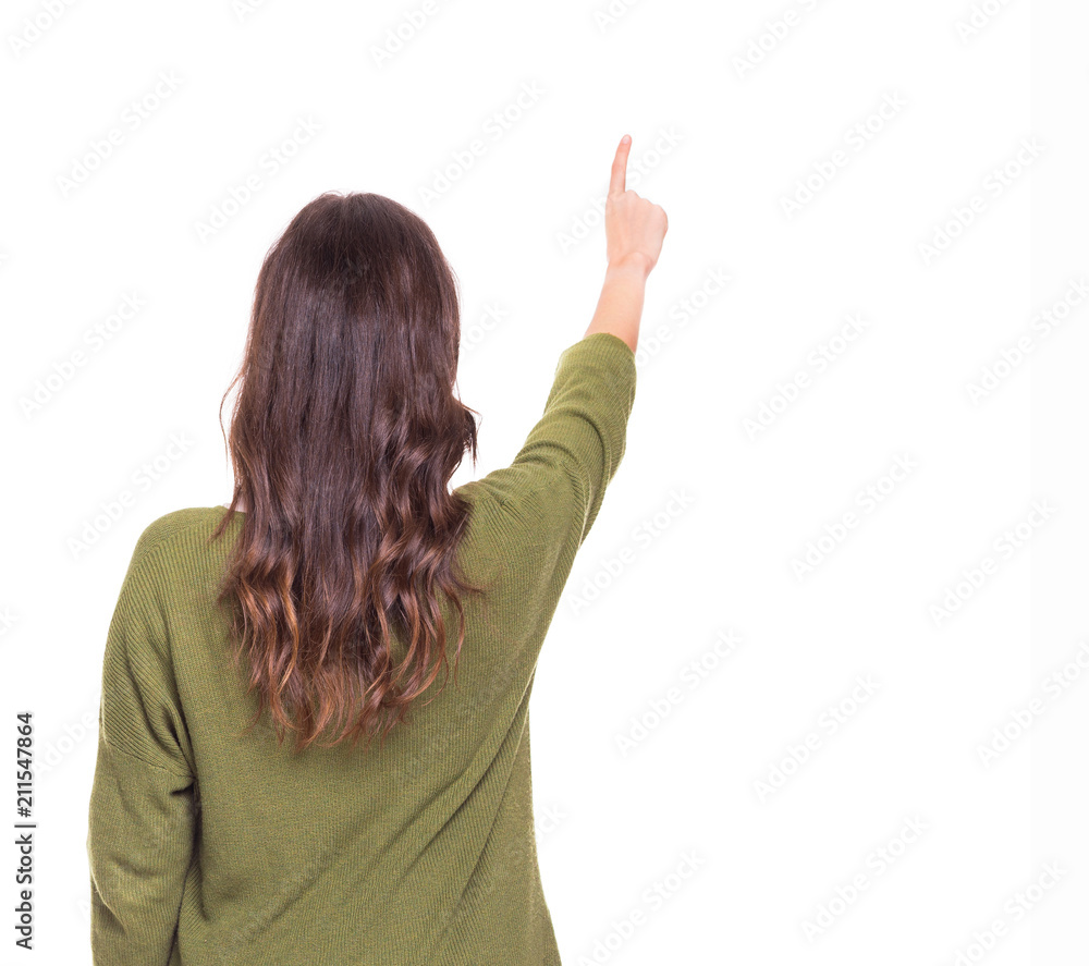 Back view of a young girl pointing, isolated on a white background