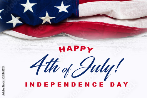 United states flag on white, weathered clapboard background with greeting. Independence Day