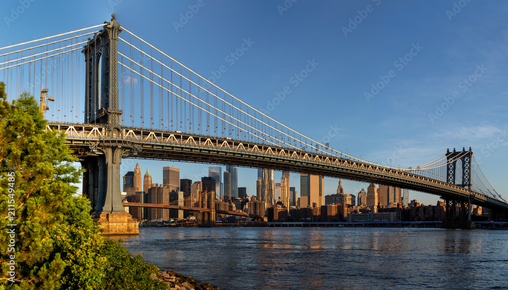 New York City / USA - JUN 25 2018: Brooklyn Bridge Park with Lower Manhattan skyline at sunrise