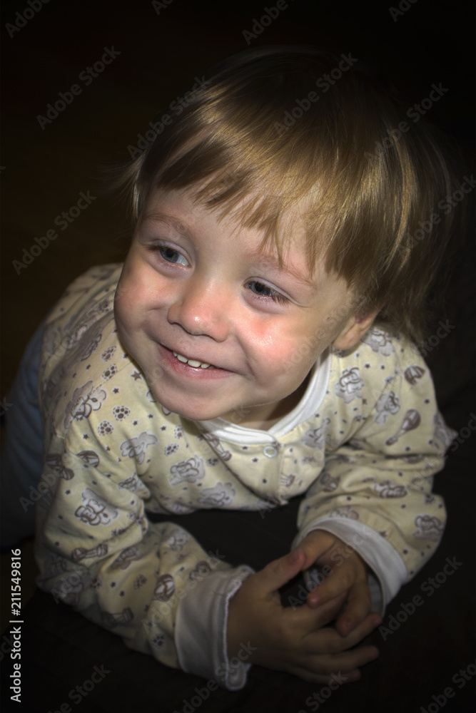 Little cute smiling blonde boy posing in front of camera, expressive portrait Little cute smiling blonde boy posing in front of camera, expressive portrait