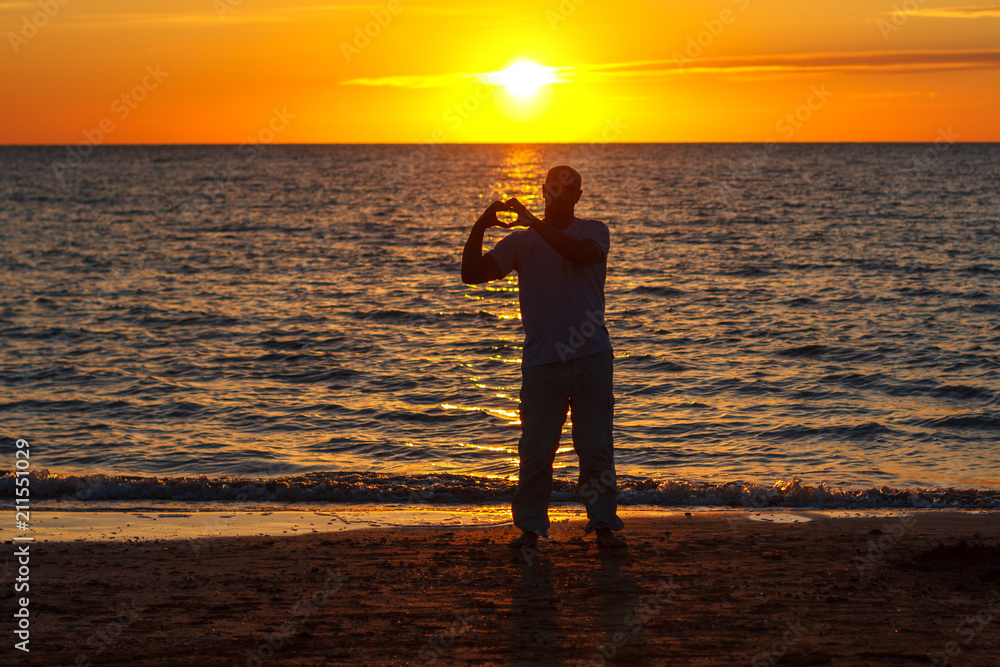 a man enjoys life on the beach at sunset