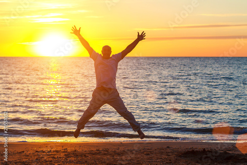 a man enjoys life on the beach at sunset