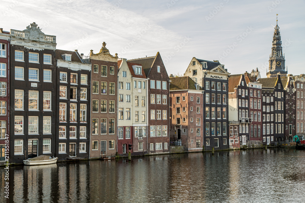 A Row of Brown Townhouses on a Canal in Amsterdam