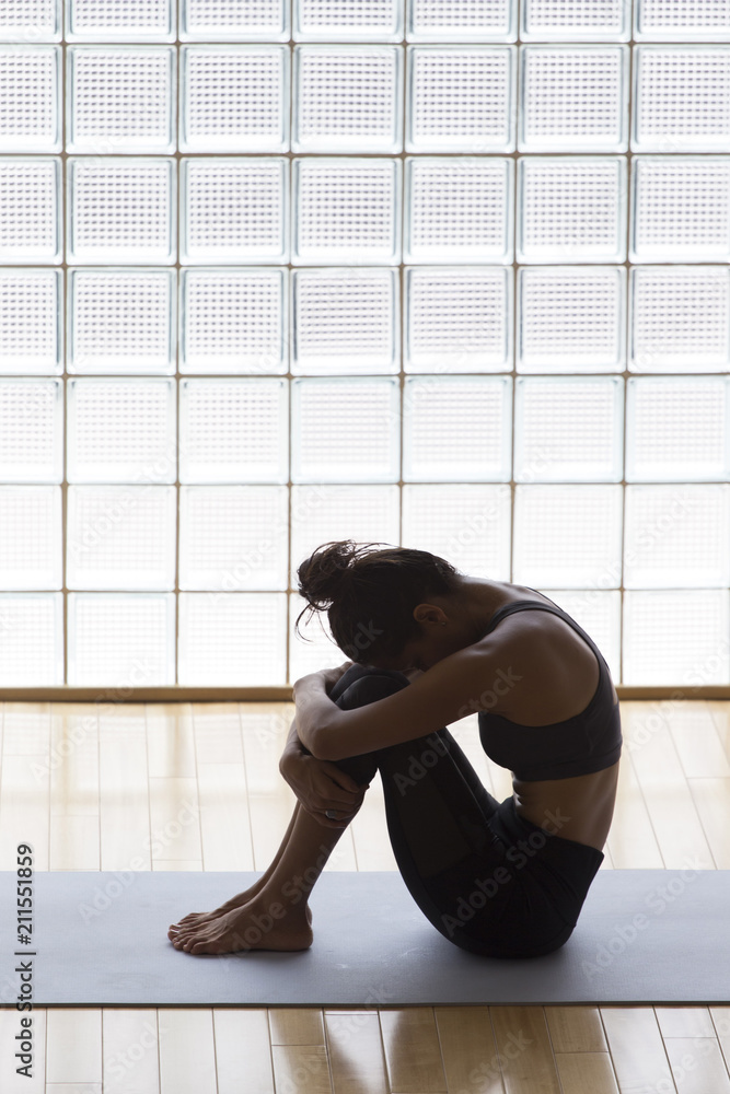 Fototapeta premium Woman hugging her knees