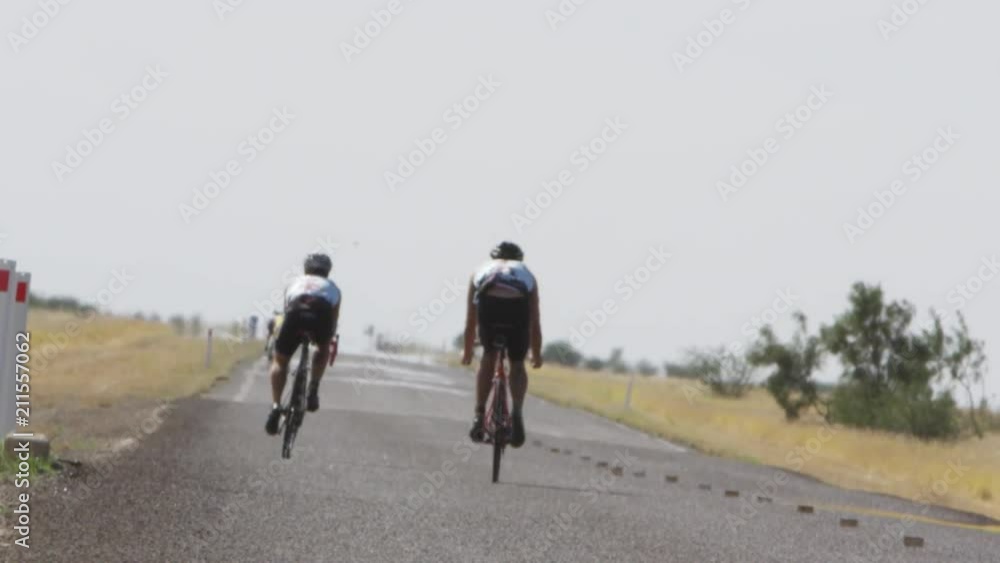 A two shot of two bikers riding in slow motion A two shot of two bikers riding in slow motion